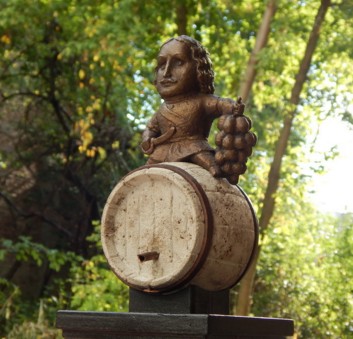 Mini-sculpture of Peter the Great against the background of trees